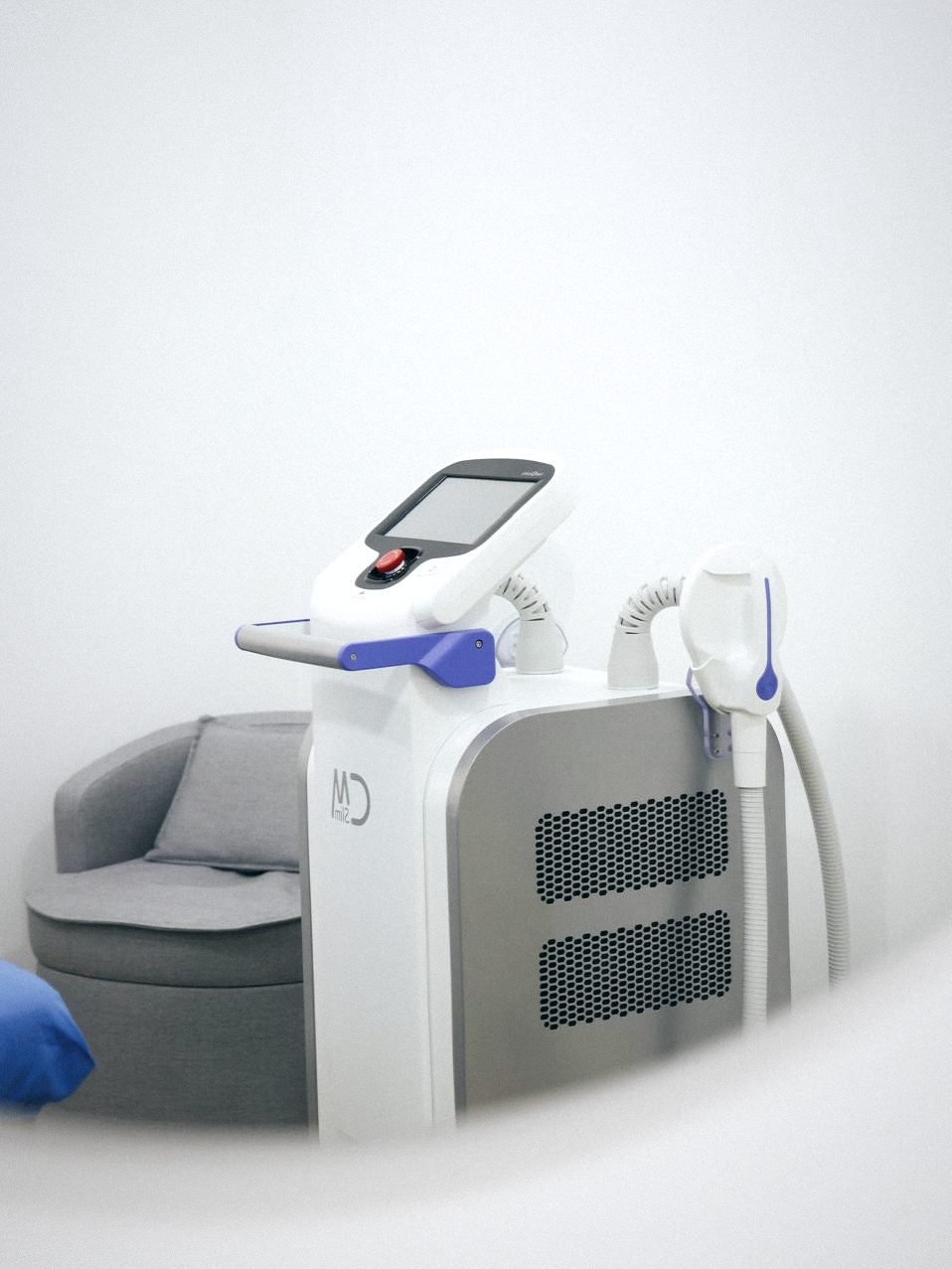 A treatment room at Dreambody, with a body sculpting device and armchair